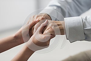 Nurse holding senior man s hands sympathy . High quality and resolution beautiful photo concept