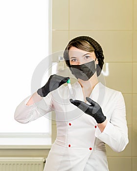 Nurse holding test tubes photo