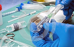Nurse holds ampoule of anesthesia, preparation to extract cerebrospinal fluid to investigate causes in a person affected by photo