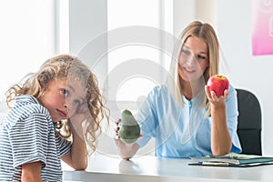 Nurse holds apple and avocado, healthy diet plan concept