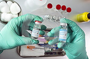 Nurse holds two covid-19 vaccines from different laboratorie