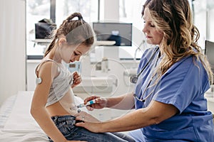 Nurse injecting insulin in diabetic girl belly. Close up of young girl with type 1 diabetes taking insuling with syringe