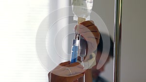 Nurse injecting medicine in infusion