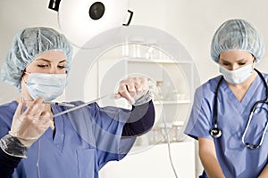 Nurse injecting with syringe into iv tube photo