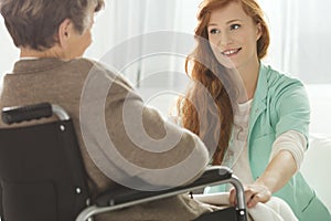 Nurse looking at elder woman photo