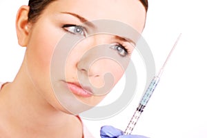 Nurse looking at a syringe