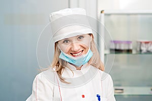 Nurse with lowered mask in hospital