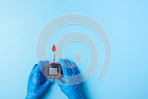 Nurse making a blood test with red blood drop with Blood glucose test strip and Glucose meter