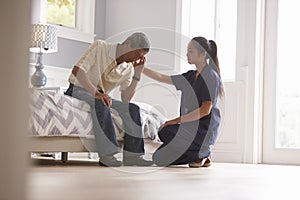 Nurse Making Home Visit To Depressed Senior Man