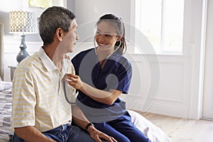 Nurse Making Home Visit To Senior Man For Medical Exam