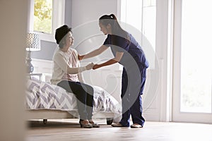 Nurse Making Home Visit To Senior Woman photo