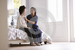 Nurse Making Home Visit To Senior Woman For Medical Exam