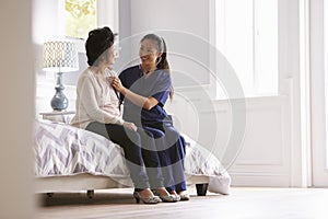 Nurse Making Home Visit To Senior Woman For Medical Exam