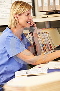 Nurse Making Phone Call At Nurses Station