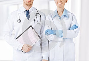 Nurse and male doctor holding cardiogram
