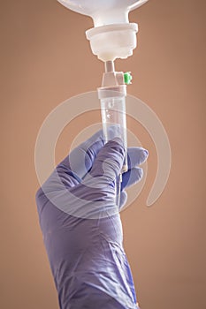 Nurse managing fluid with a dropper