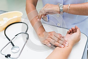 Nurse is measurement radial pulse at the wrist of the patient.