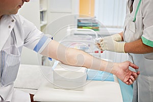 Nurse in medical center going to draw blood from