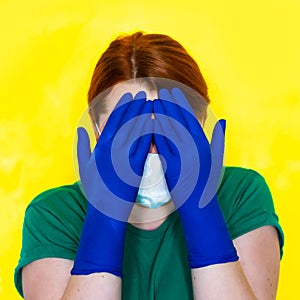 Nurse in medical mask and gloves clutched her head