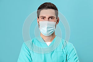 Nurse with medical mask on light blue background