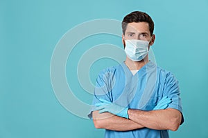Nurse with medical mask on light blue background, space for text