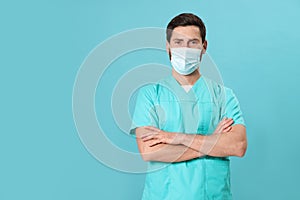 Nurse with medical mask on light blue background, space for text