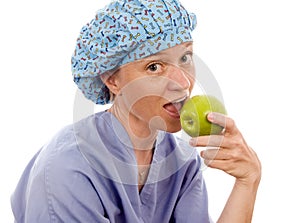 Nurse medical person eating granny smith apple