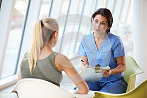 Nurse Meeting With Teenage Girl In Modern Hospital