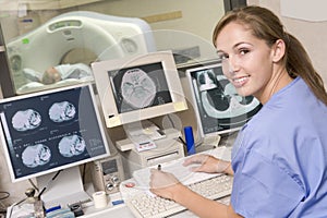 Nurse Monitoring Patient Having CAT Scan