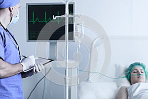 Nurse monitoring patient's vital functions