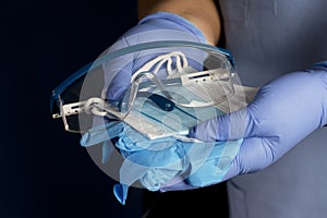 Nurse Offers Personal Protection Masks, Gloes And Safety Glasses