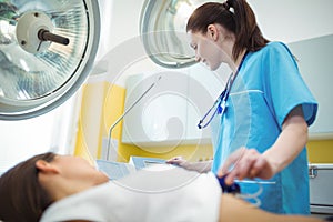 Nurse performing an electrocardiogram test on the patient