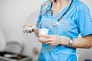Nurse with pillbox and a cup of water