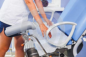 The nurse places a clean towel on the examination table