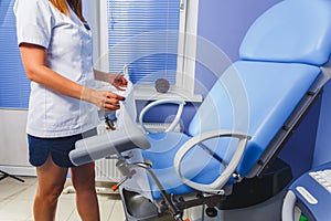 The nurse places a clean towel on the examination table