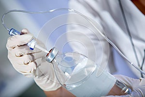 Nurse prepares IV solution for infusion.