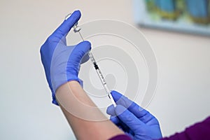 A nurse prepares to administer Pfizer-BioNTech COVID-19 vaccine photo