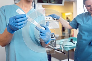 Nurse preparing anesthetic for surgery in hospital