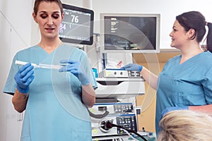 Nurse preparing anesthetic for surgery in hospital