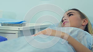 Nurse preparing female patient`s arm to put IV tube