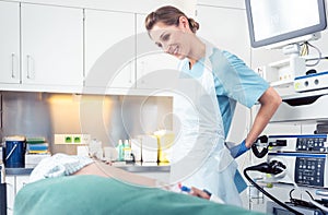 Nurse preparing herself and patient for endoscopy
