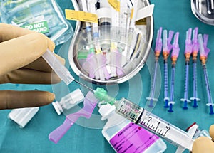 Nurse preparing hospital medication, needle safety closure, conceptual image