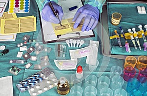 Nurse preparing hospital medication, placing dose medicine in glass monodose, conceptual image
