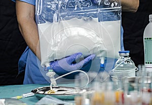 Nurse preparing medication for parenteral nutrition in a hospital