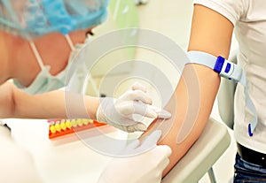 Nurse preparing to make an injection for blood taking.