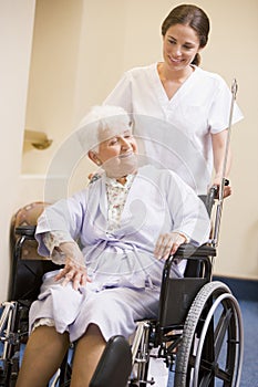 Nurse Pushing Woman In Wheelchair