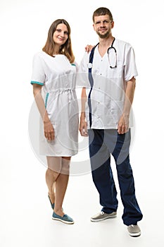 the nurse put her hand on the doctor\'s shoulder  both happily look into the frame  full length