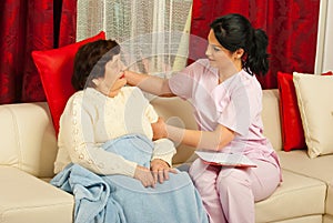 Nurse put a pillow to senior woman