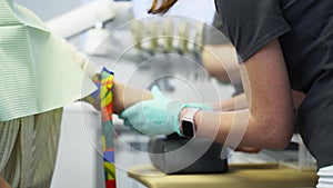 Nurse puts on a blood tourniquet on patient`s arm. Preparation for blood test with by female doctor in medical uniform