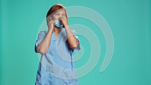 Nurse putting on medical face mask